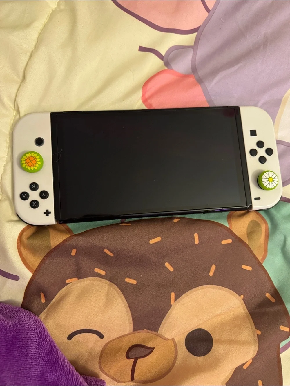 Nintendo White Handheld Console with Yellow-Green Flower Thumbstick Caps